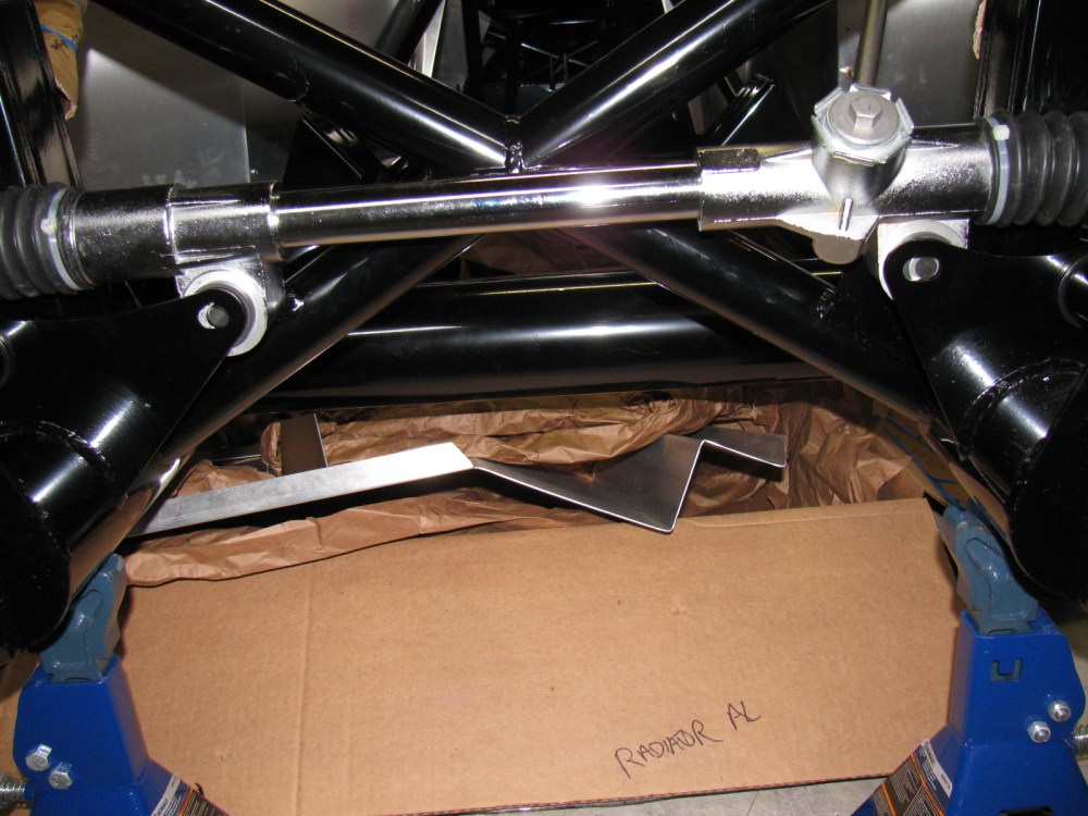 Compare the hole on the left (I used silver marker to show where to enlarge the hole) and the slot on the right. No reaming needed - I used a punch and a mallet to move the steering rack into place. 