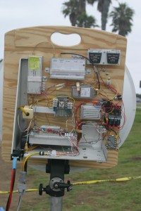 Figure 5. The Farinon SSPA installed in “Ms. June,” my latest 10GHz rig. Two watts appears at the waveguide port at the antenna relay in transmit. The DC-DC converters are enclosed in separate chassis boxes, and can be seen just to the right of the amplifier. A re-labeled surplus meter monitors amplifier operation.