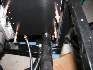 A close-up of the small cut needed on the left side of the battery box. This cut-out does not interfere with the battery - but the battery clamp bar may have to be moved, depending on where terminals, vents or filler caps are on the battery.